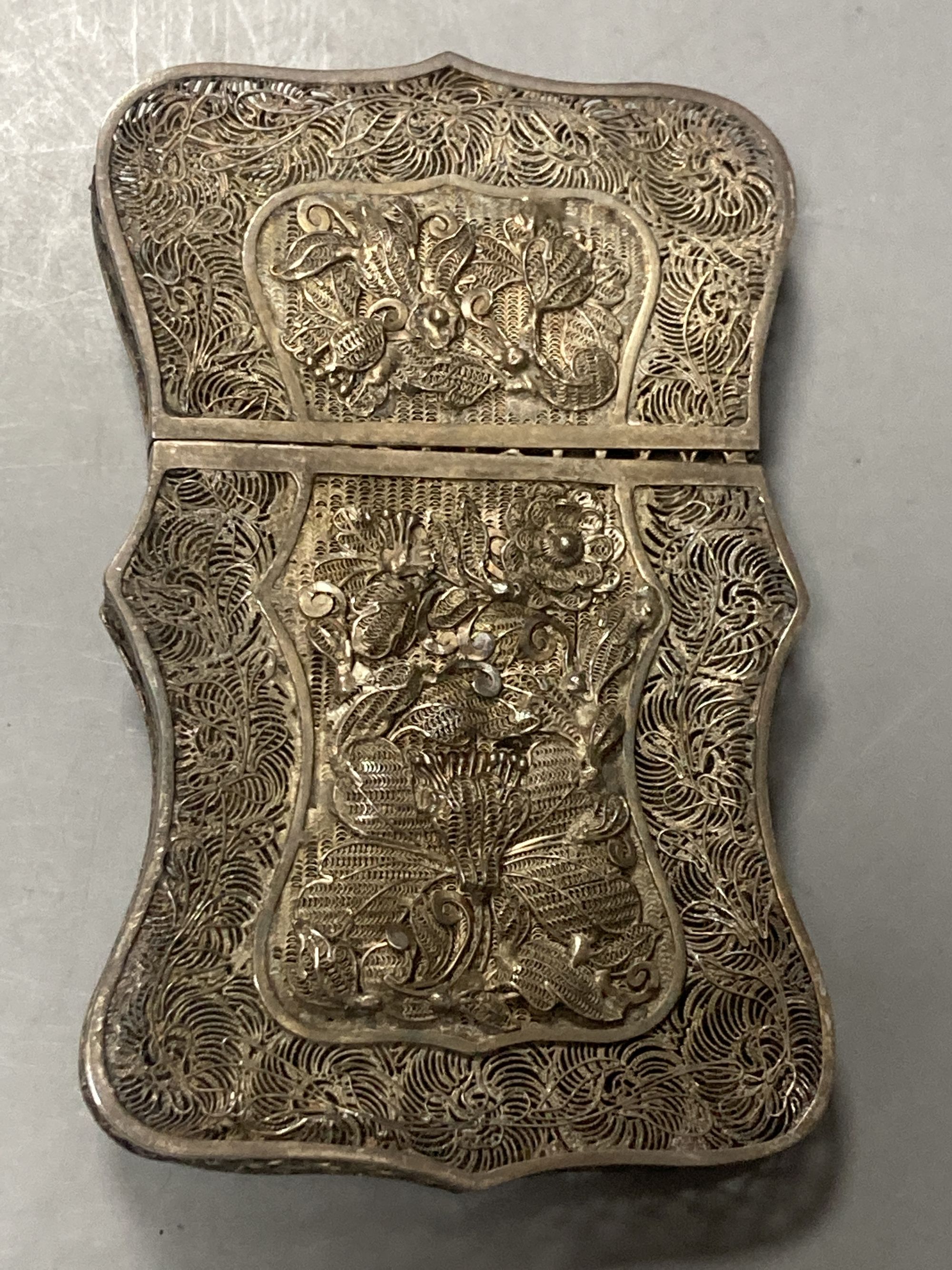 Two Chinese white metal filigree card cases, one with enamel(a.f.) & an Indian white metal snuff box, largest 91mm.